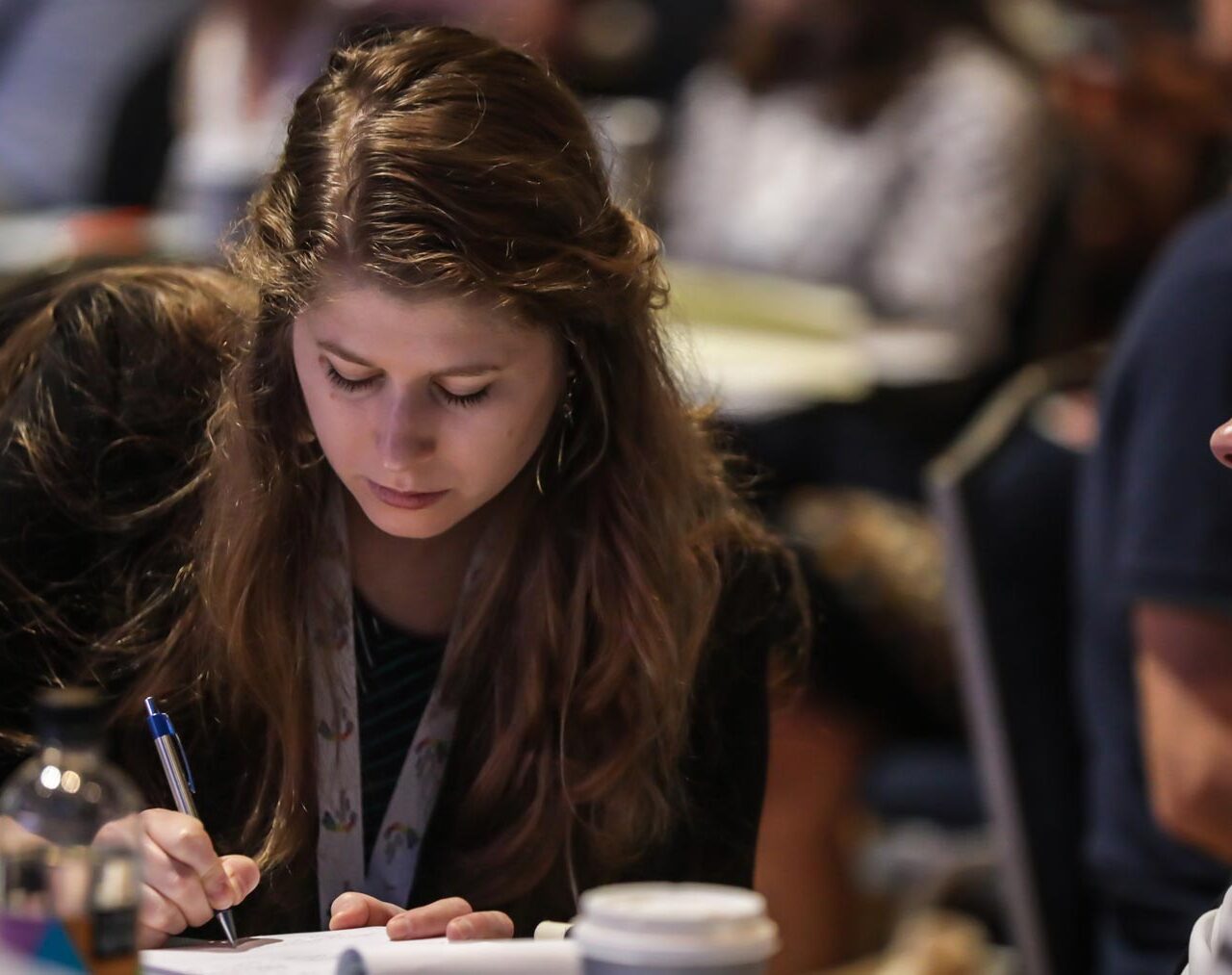 Woman taking notes at a conference