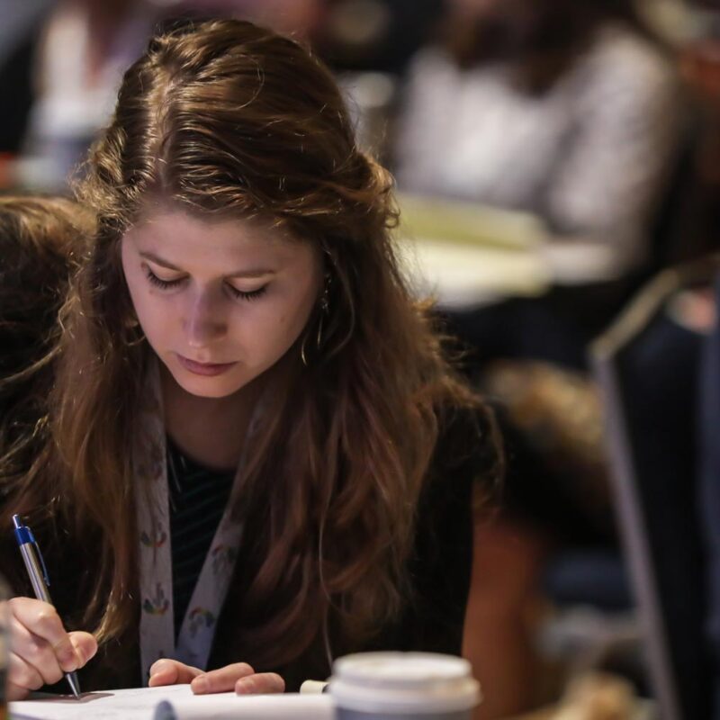 Woman taking notes at a conference